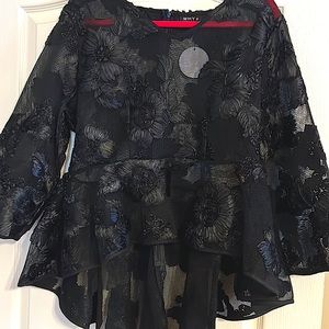 A black dressy top with Embleshed black flowers.  The top is considered formal,